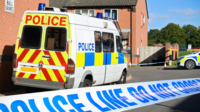 Police van with police tape at a crime scene