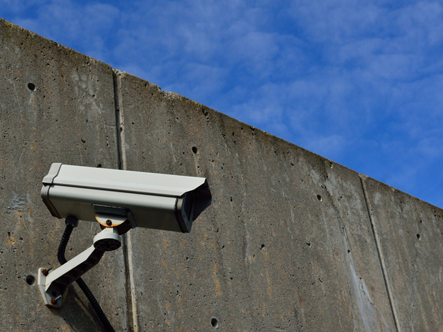 A CCTV camera mounted on a concrete wall