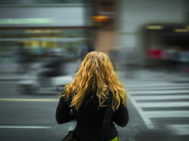 Woman crossing busy road