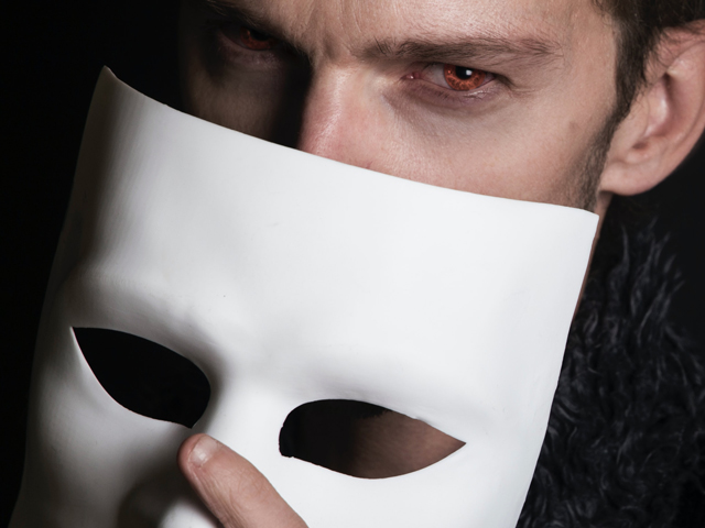 Man holding theatre mask