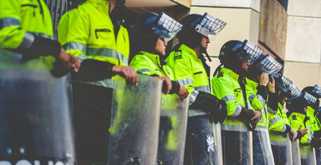 A line of police with riot shields