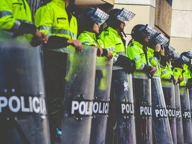 A line of police with riot shields