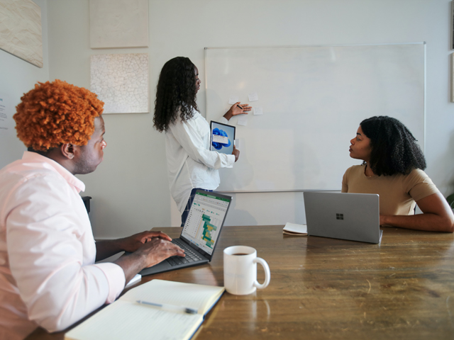 Three women in a meeting room