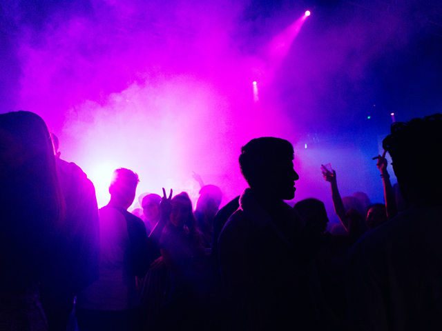 A nighclub with lights and silhouettes