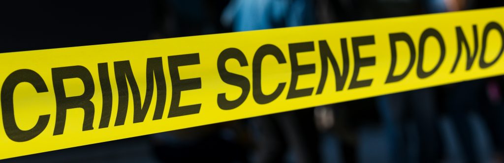 Yellow banner with black text reading crime scene
