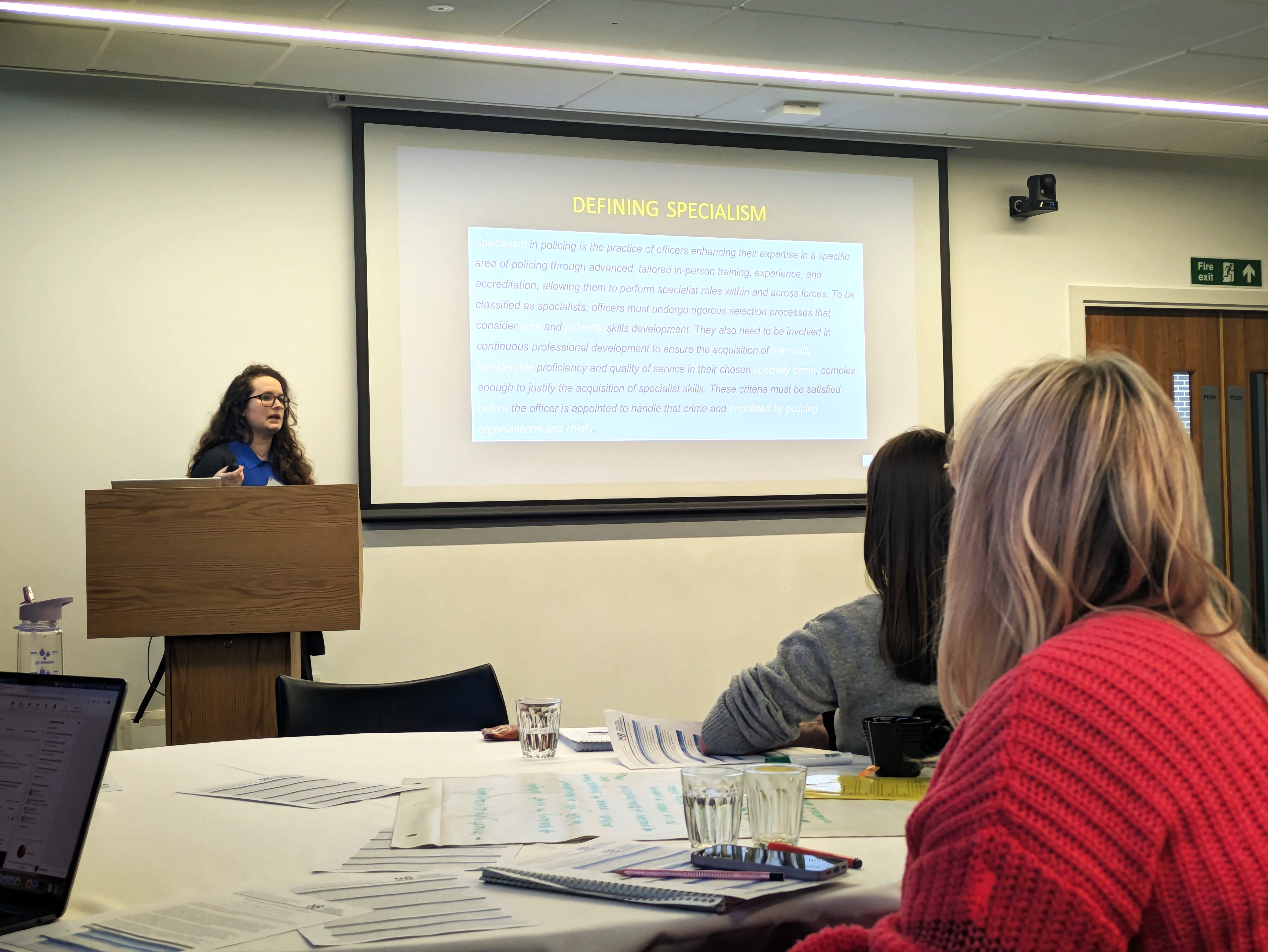 Woman gives a presentation at a lectern 