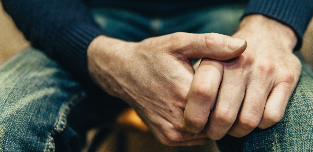 Close up of man's hands clasped