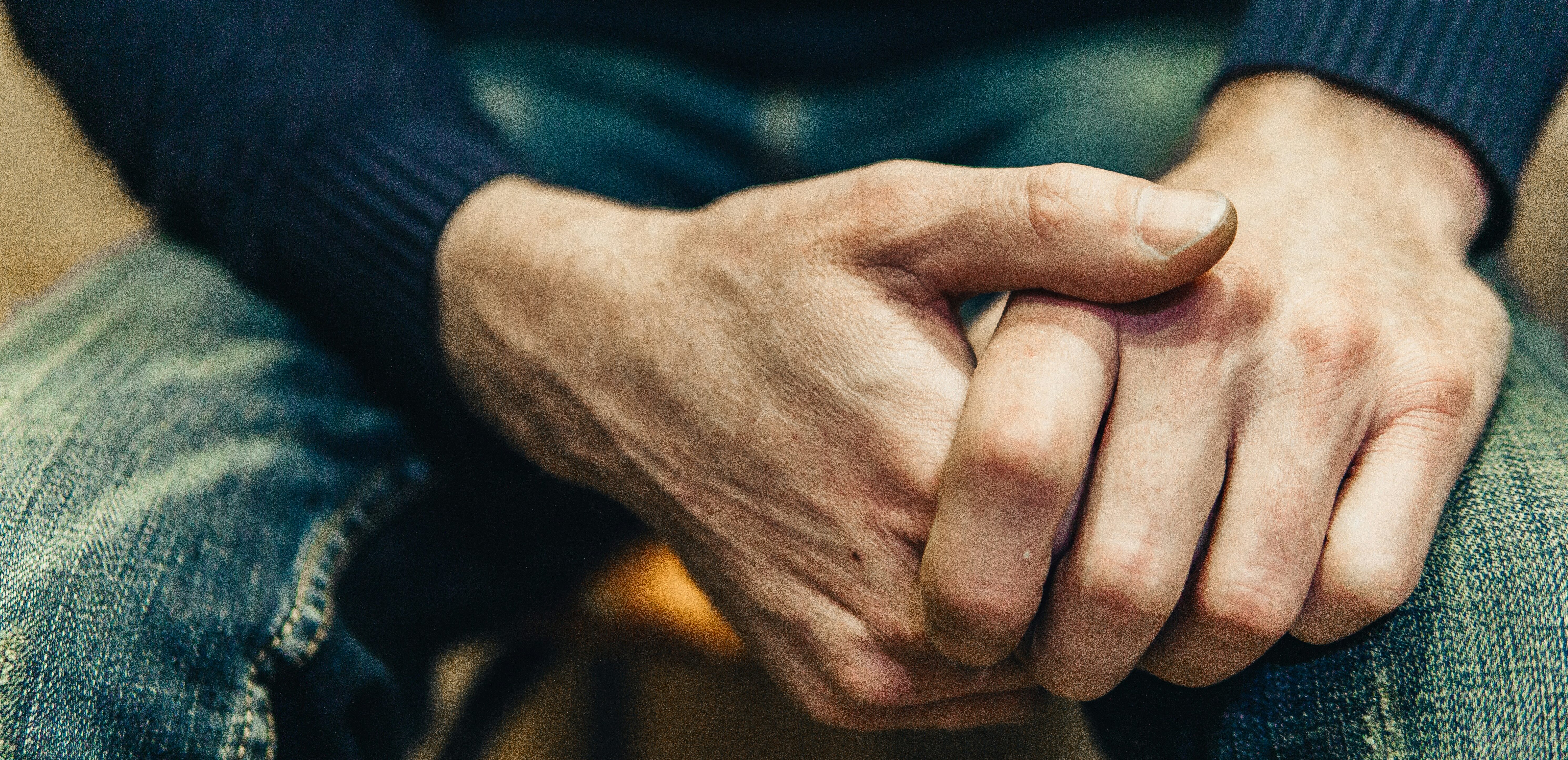 Close up of man's hands clasped